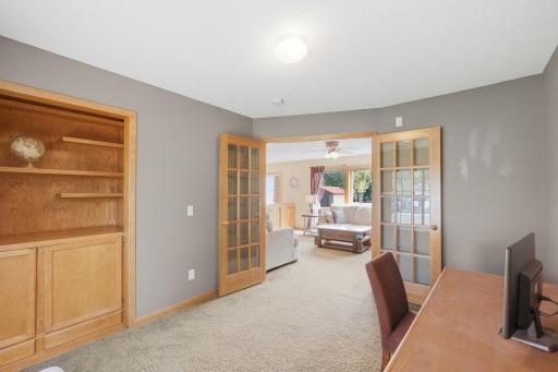 The main level features an office space with built-ins, frech doors and great lighting!