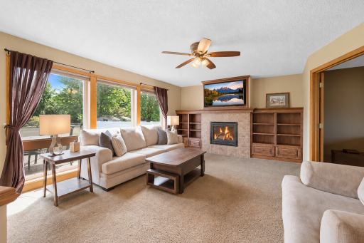 This living room offers great lighting, picturesque windows, custom built-ins and fireplace.