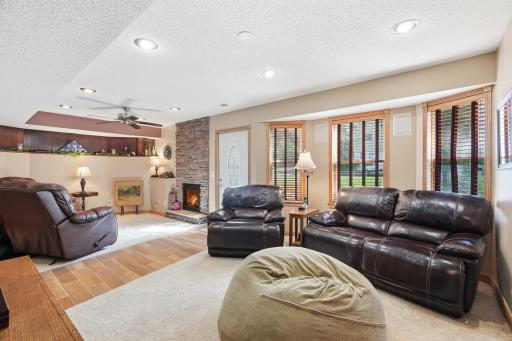 LL Family Room with a gas Fireplace with Stone to the ceiling, a Bay Window and Walkout to a Patio!