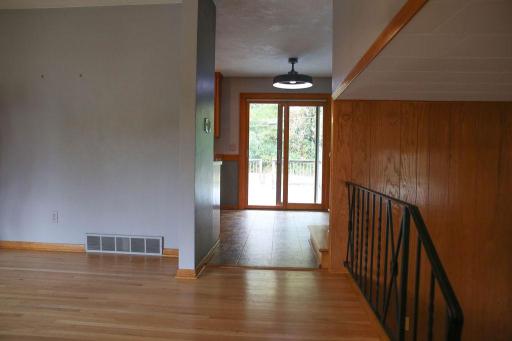 Main Level view from Foyer- Showcasing sliding door to outdoor living space.