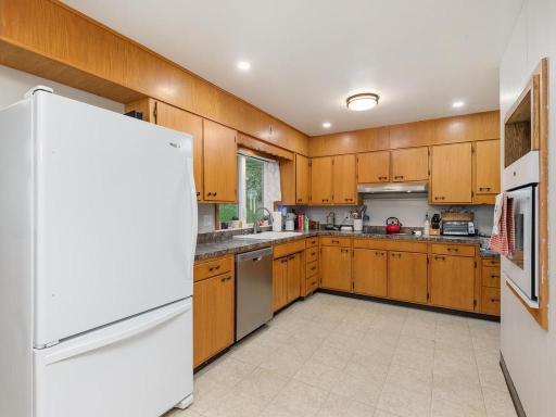 Kitchen offers abundant cabinetry, counter space, and a new dishwasher.