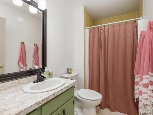 Main-level full bathroom with an updated vanity and fixtures.