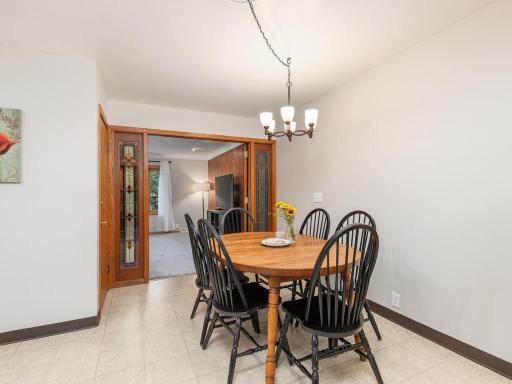 Dining area with decorative French doors leading to the living room.