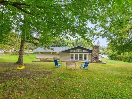 Enjoy peaceful backyard views beneath a canopy of mature trees.