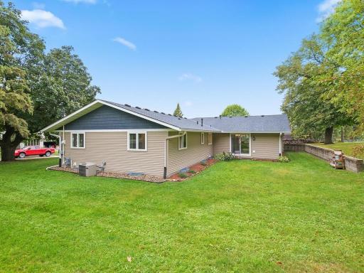 Rear exterior view highlights the homeâs spacious yard and updated siding.