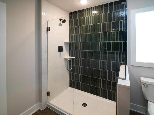 Owners suit walk in shower with frameless glass