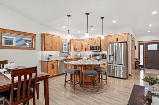 The kitchen offers a center island with seating and generous workspace.