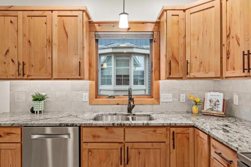 A window above the sink brings natural light into the kitchen.
