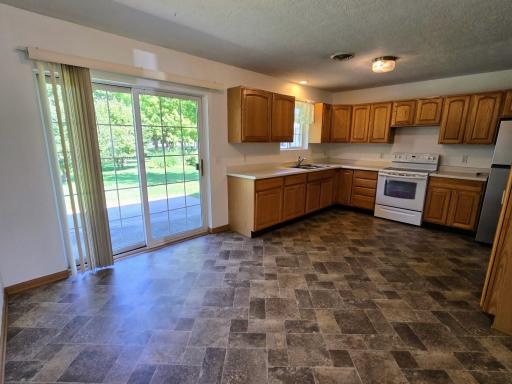 Dining & kitchen feature the north side sliding patio doors to 10 x 12 cement patio which makes the kitchen bright & cheery!