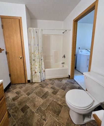 Bathroom is conveniently located off of the laundry room.