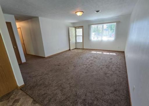 Carpeted living room area captures the southern sunshine. Plus convenient hallway closet.