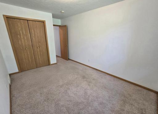 North bedroom is 13 x 9.6. Carpeted with single closet.