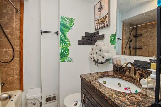 Full bathroom with grantie counter top on main level