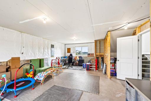 Unfinished basement currently used as a play area.