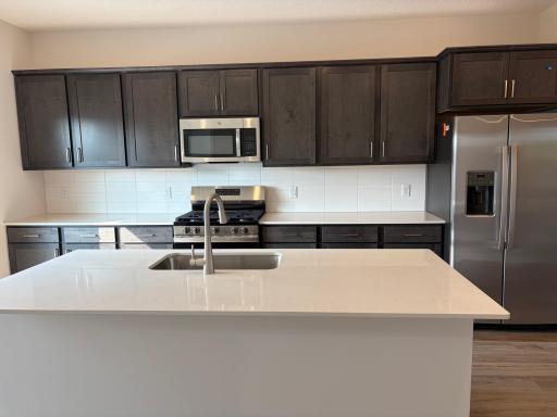 Welcome to the Barcelona! This home’s kitchen features an oversized island and all the kitchen appliances. With plenty of seating for those on the go for the early mornings!
