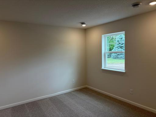 At the entry of the home, we have a spacious rec. space that is great, as a secondary living area, office, or even a makeshift 4th bedroom when you need added space!