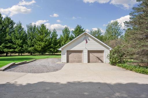 Detached 26X26 garage with loft, concrete driveway, and extra parking pad.