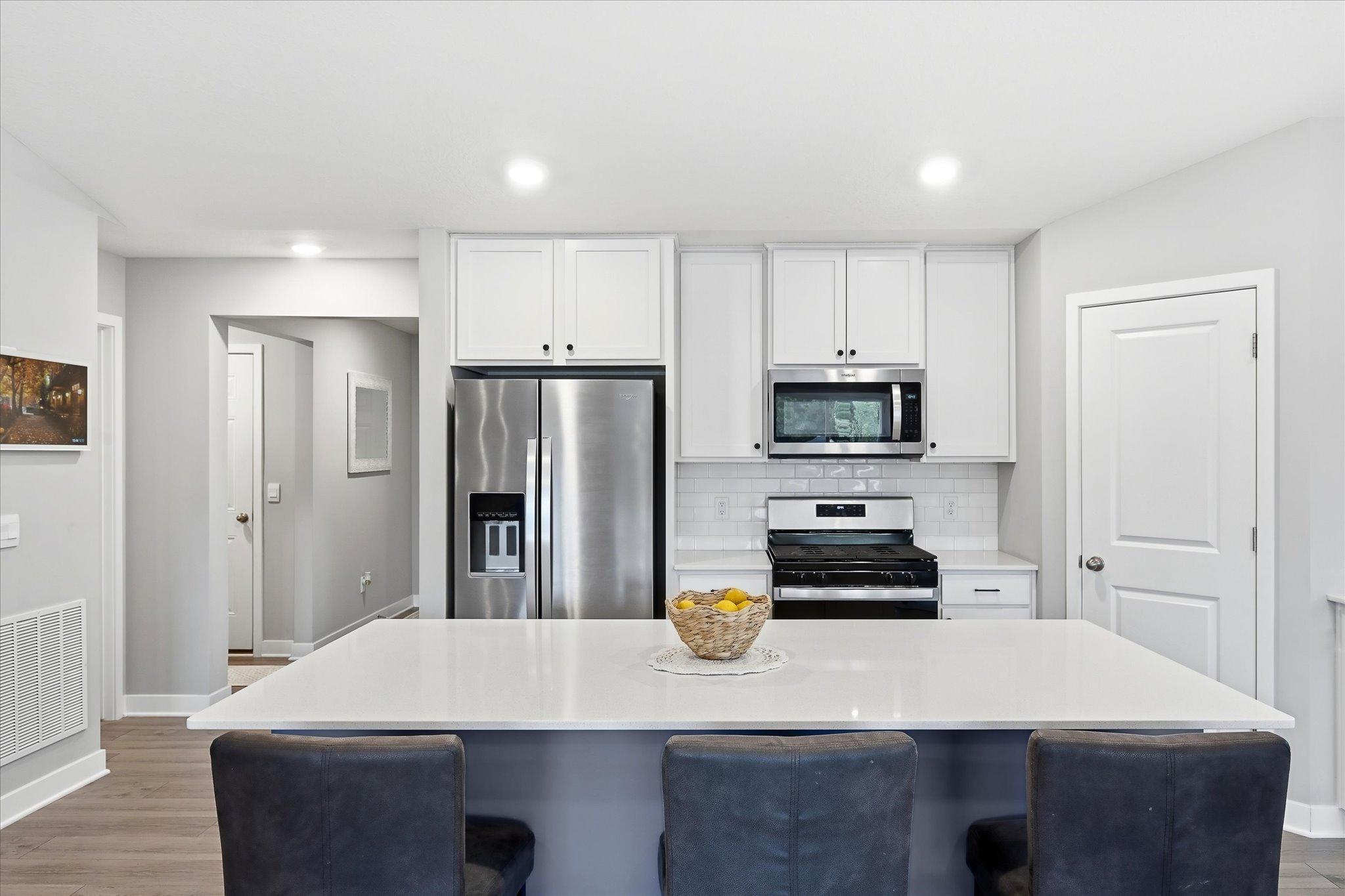 A spacious center island provides additional prep space, casual seating, and a natural gathering spot.