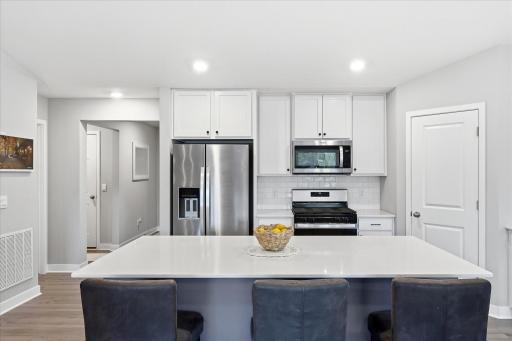 A spacious center island provides additional prep space, casual seating, and a natural gathering spot.