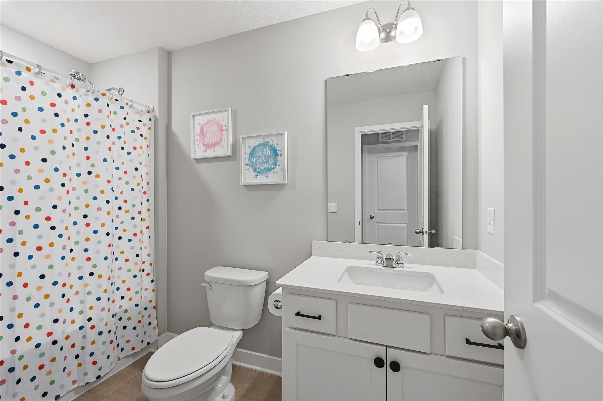 An additional full bath adds convenience to the lower-level living area.