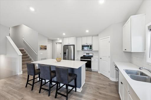 Thoughtful kitchen design with a pantry, generous workspace, and convenient access to the dining area.