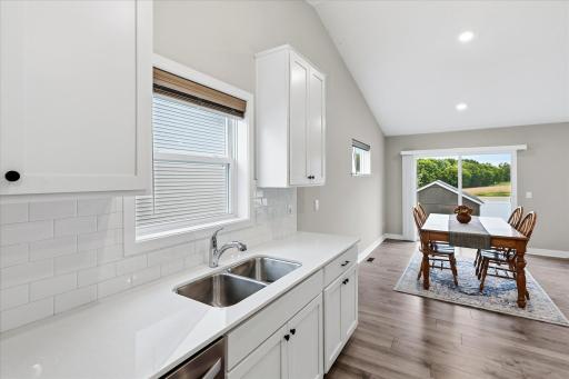 A beautiful tiled backsplash adds a stylish finishing touch to this inviting kitchen.