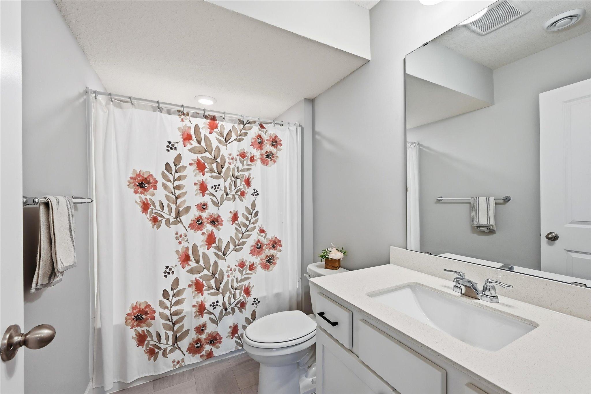 Full bathroom serves the secondary upper-level bedrooms.
