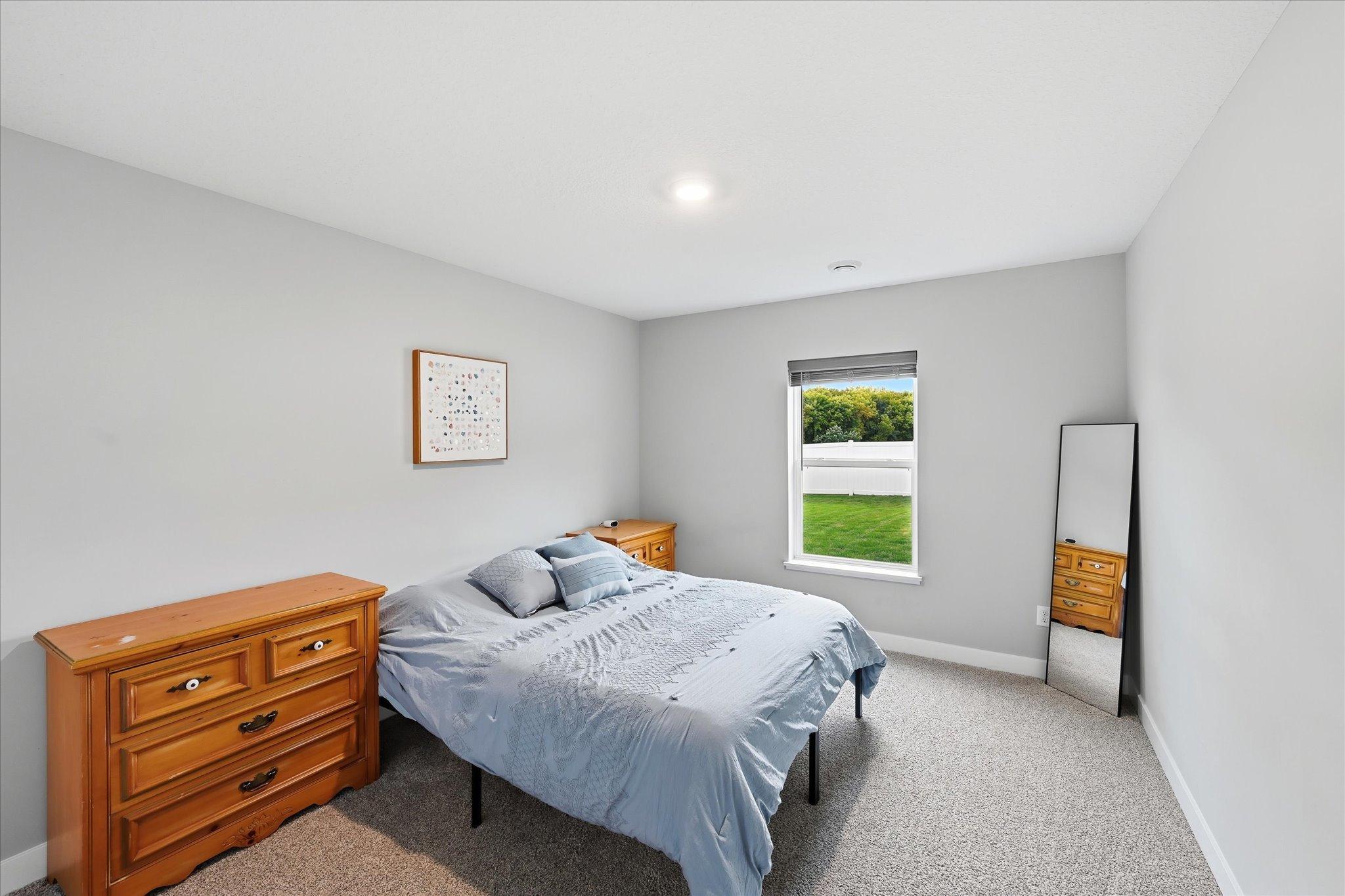 The lower-level bedroom offers a comfortable space with convenient access to a full bathroom.