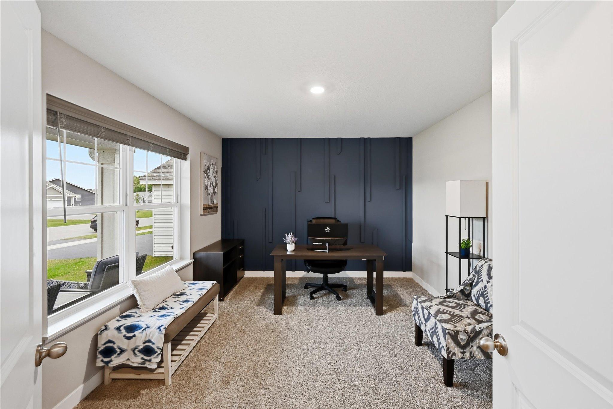 A beautiful accent wall adds personality and style to this versatile main-level bedroom - currently used as an office.