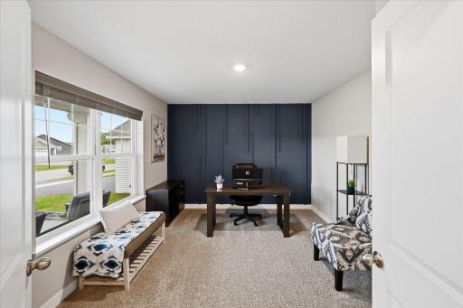 A beautiful accent wall adds personality and style to this versatile main-level bedroom - currently used as an office.