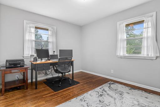 Second main floor bedroom is currently used as an office. The double windows bring in natural light.