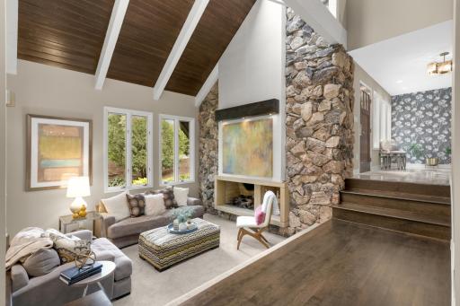 Fabulous living room with 20+ foot ceilings and stone fireplace