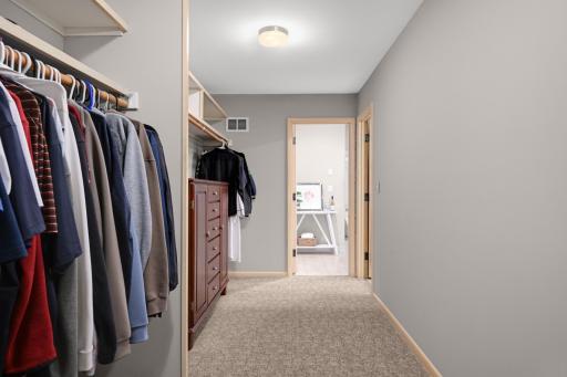 His primary closet with 1/2 bath