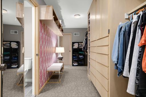 Her primary closet with 1/2 bath