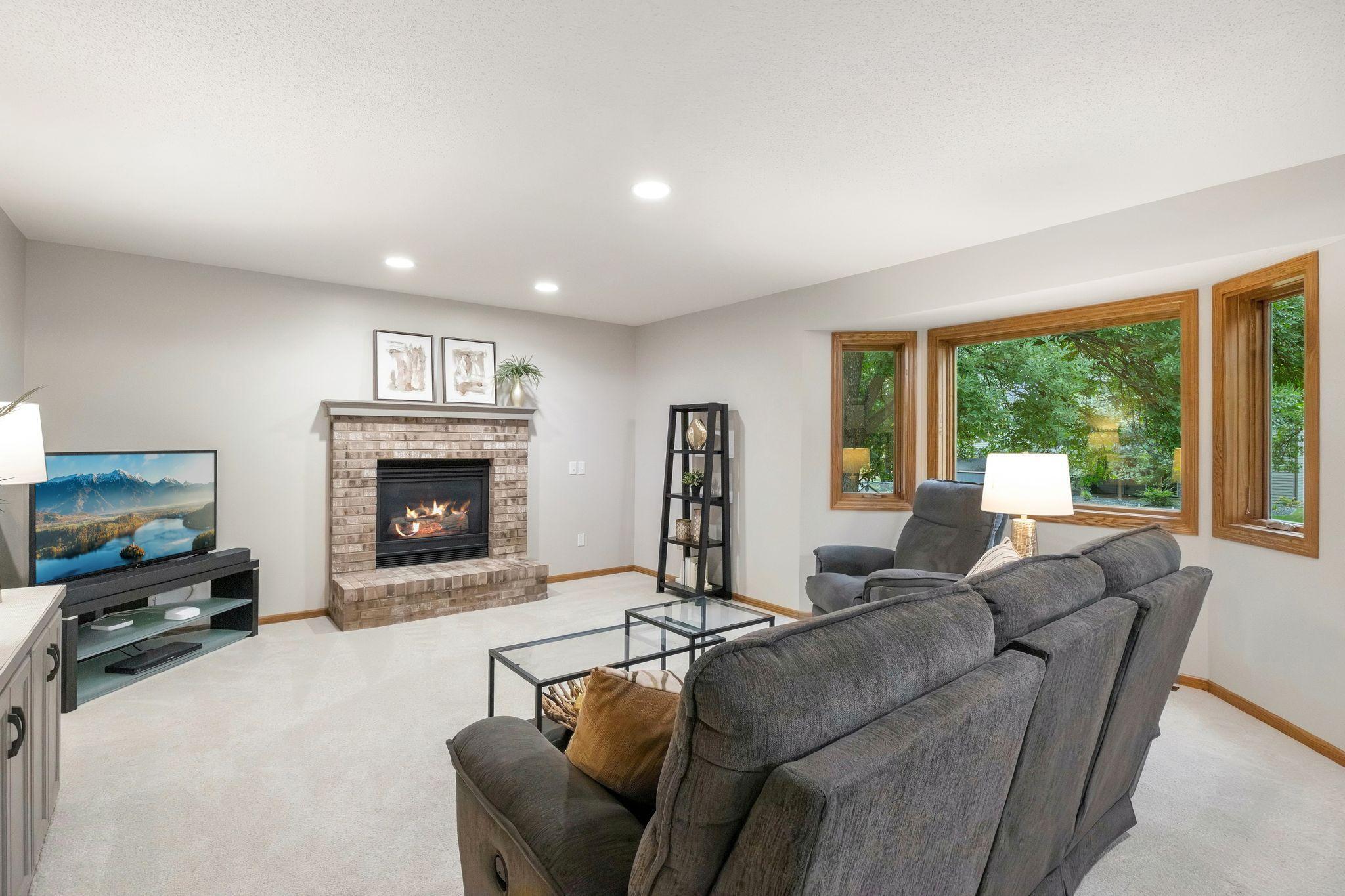 Step down into the family room with a gas fireplace and views of the backyard.