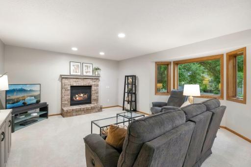Step down into the family room with a gas fireplace and views of the backyard.
