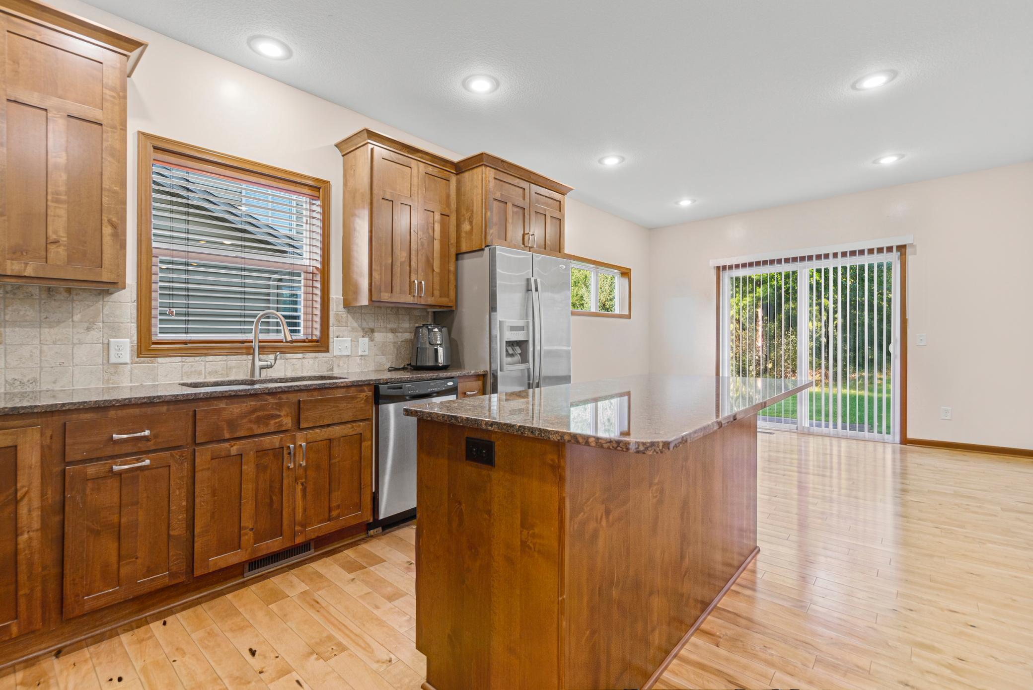 15_Kitchen with Alder cabinetry, granite counters, and center island.jpg