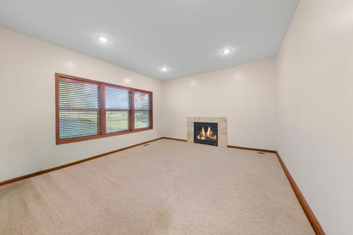 39_Living room featuring gas fireplace and stunning backyard views.jpg