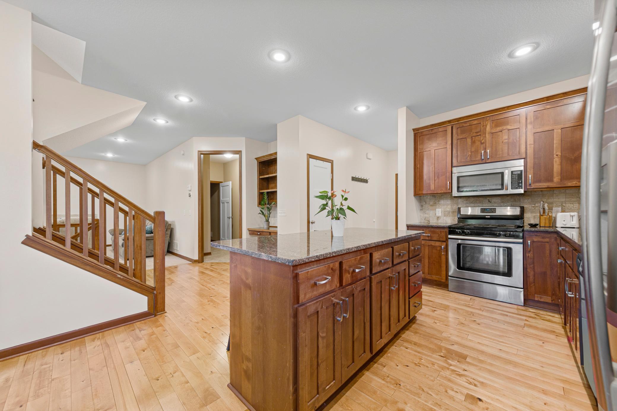 22_Kitchen with Alder cabinetry, granite counters, and center island.jpg