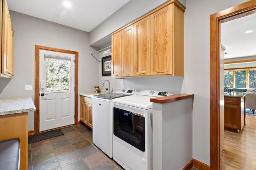 Main floor laundry with door leading out to side deck. Perfect entry from the garden area.