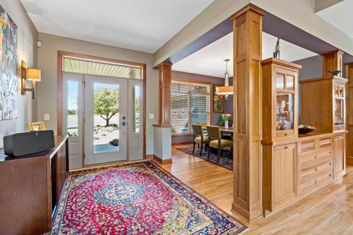 Large open foyer with beaming maple flooring throughout main level.