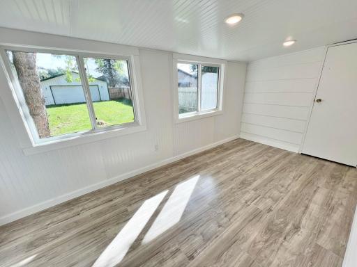View from sunroom to fenced in back yard and 2-car garage