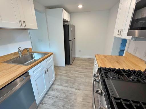Kitchen with SS appliances and view to fridge.jpg