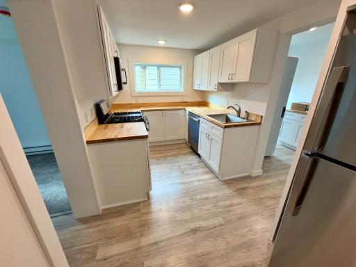 Kitchen Main view with SS appliances and awindow.jpg