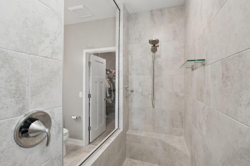 Elegant tilework, built-in bench, and glass enclosure â spa-like comfort in your own home.