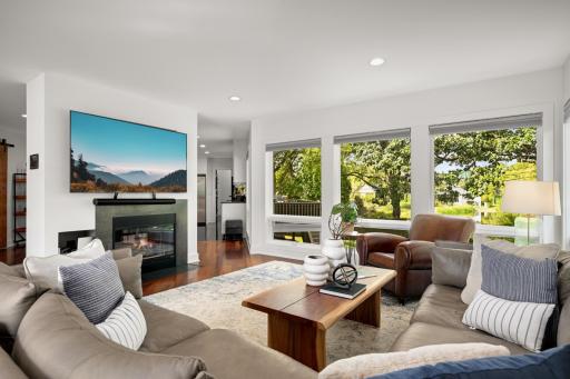 Great room with see through fireplace and huge windows to the pond views
