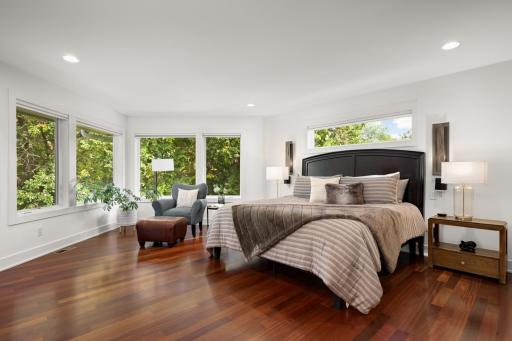 Luxurious primary suite overlooking the pond