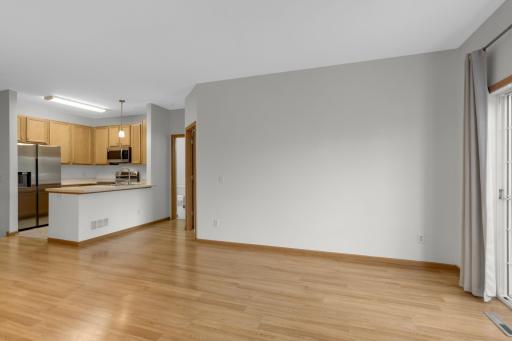 Sliding door out to deck. New stainless steel appliances in kitchen.