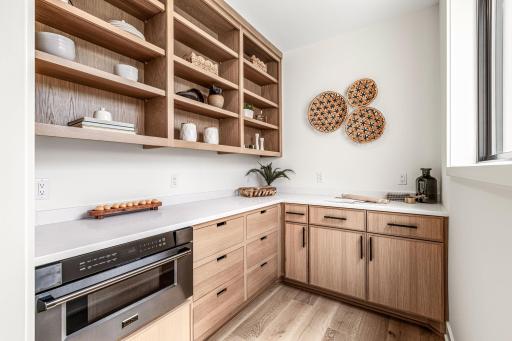 Walk-in butlers pantry with quartz countertops,