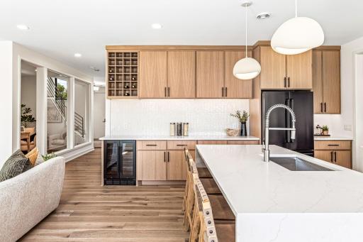 Built-in serving station with wine fridge and racking system, perfect for entertaining.